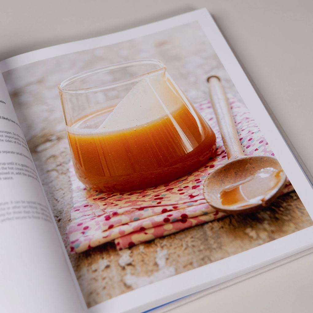 An interior photograph of a jar of sauce on a folded tea towel